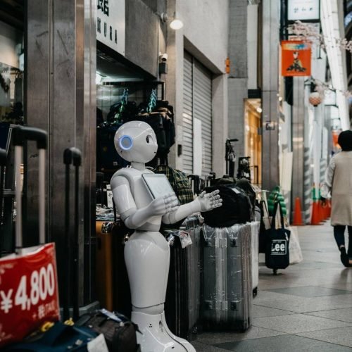 robot standing near luggage bags